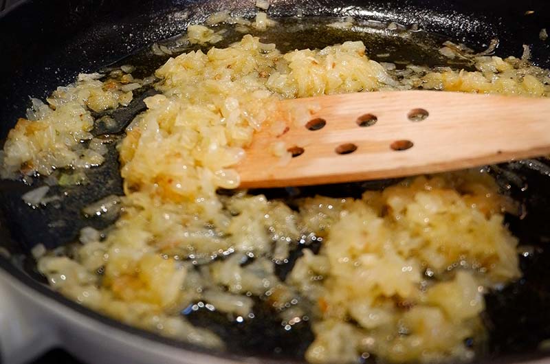 frying the onions in a pan